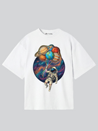 White t-shirt with an astronaut and planet balloons design on a gray background