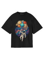 Black t-shirt with an astronaut and planet balloons design on a gray background
