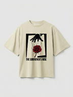 Beige t-shirt with graphic design of a hand holding a rose on a light gray background